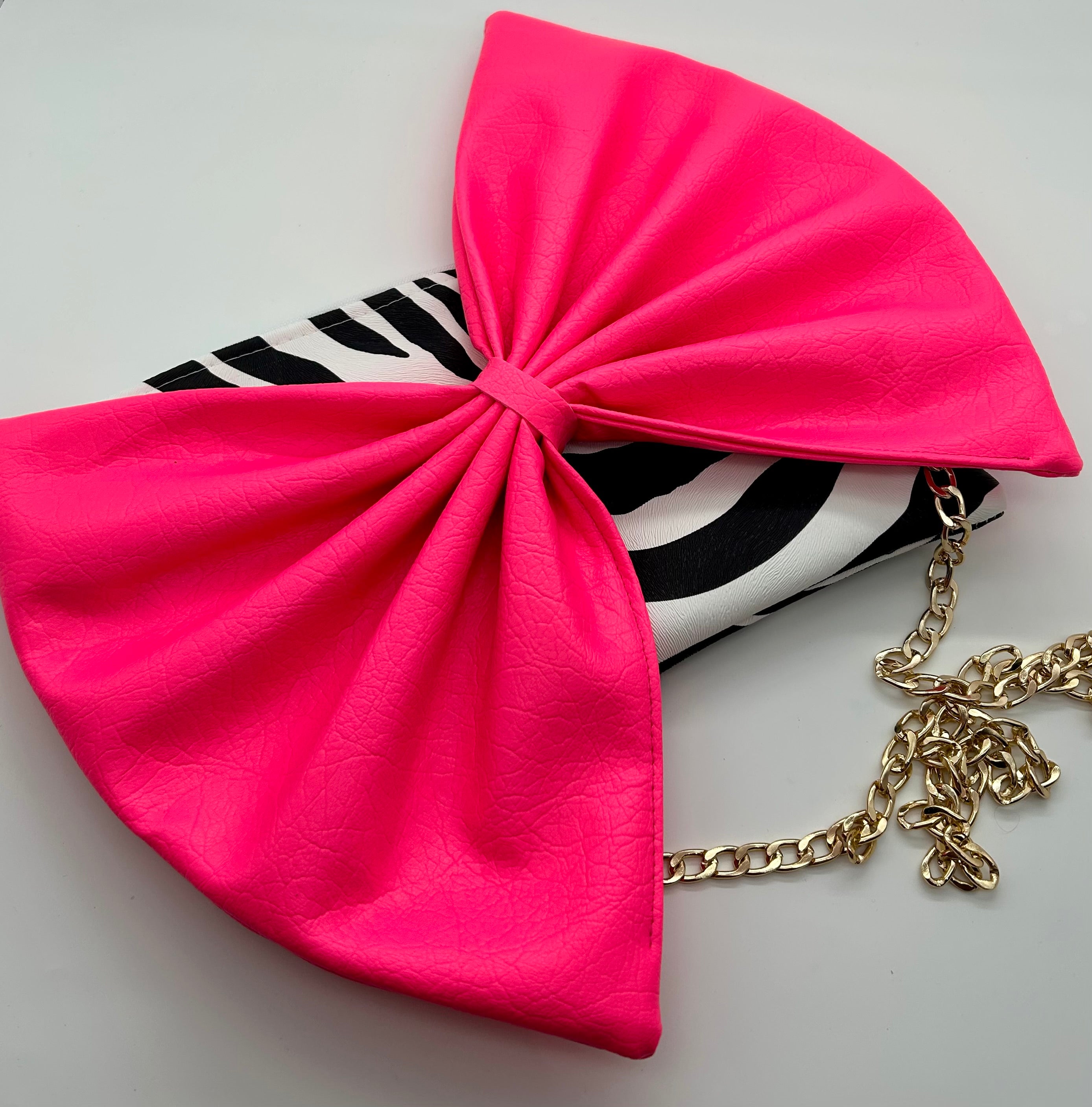 Zebra print bag with large neon pink bow