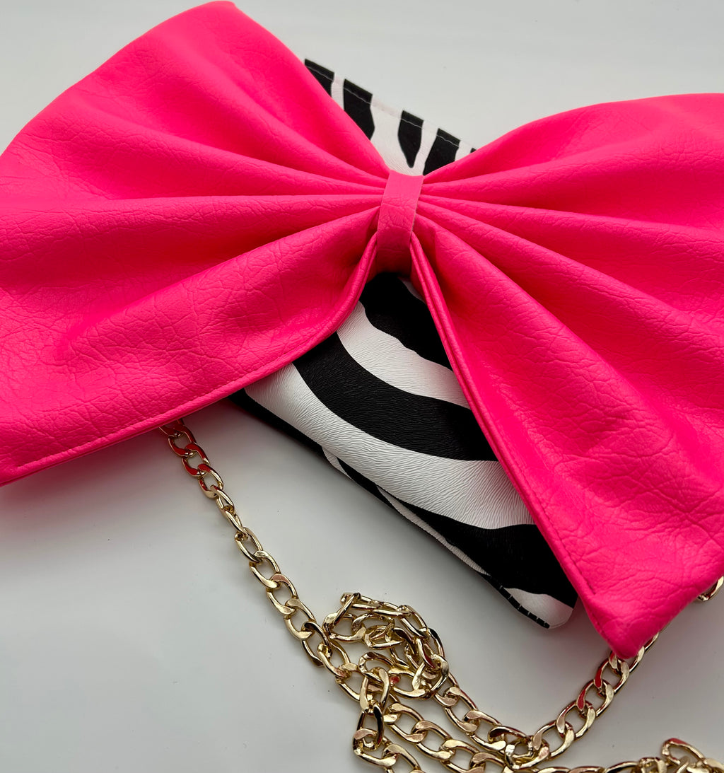 Zebra print bag with large neon pink bow