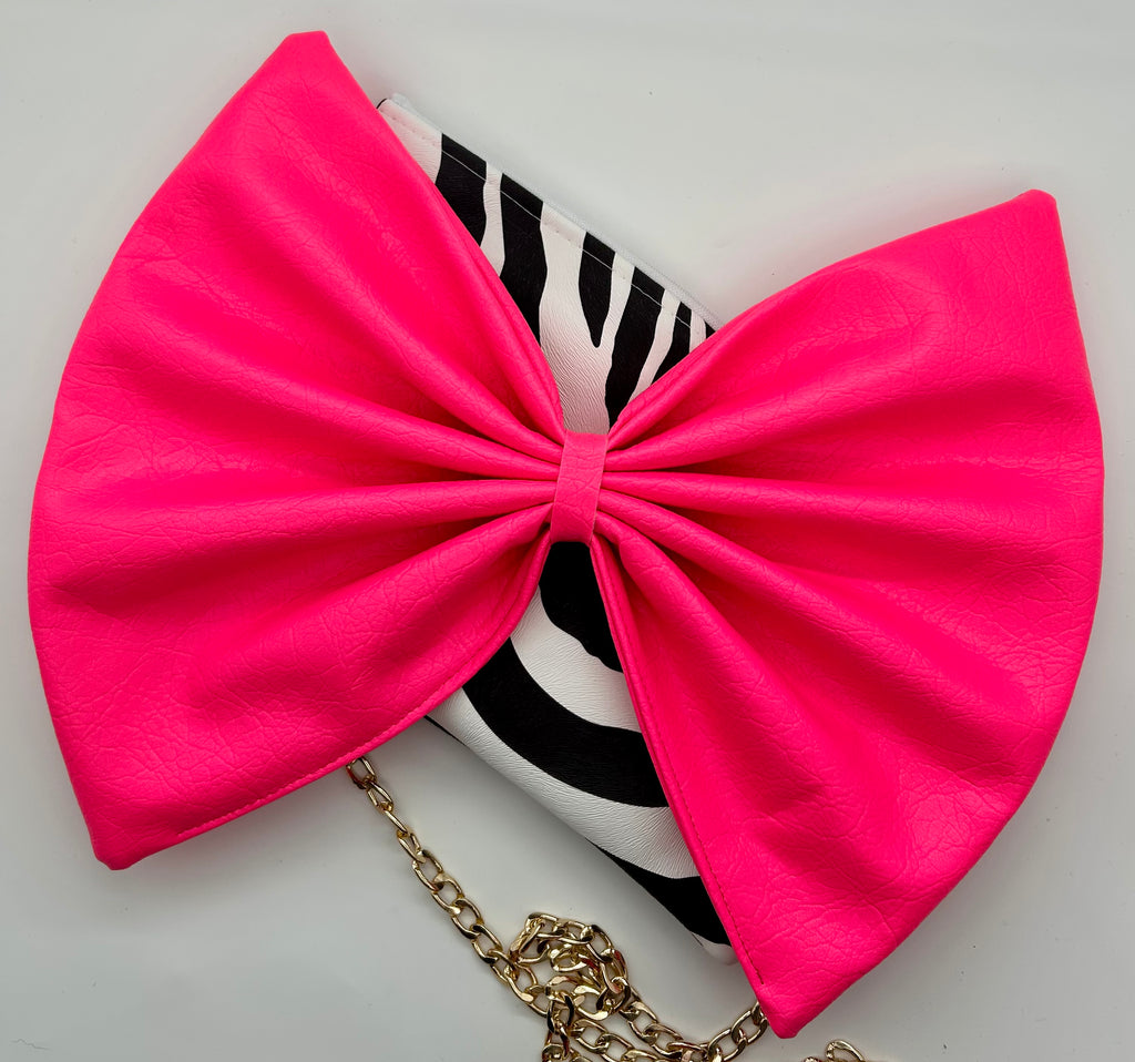Zebra print bag with large neon pink bow