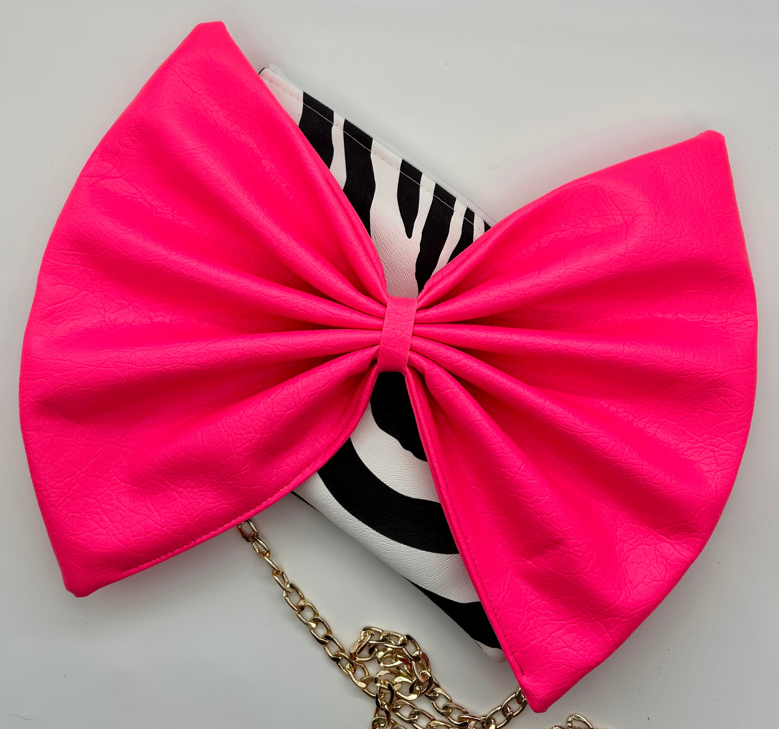 Zebra print bag with large neon pink bow