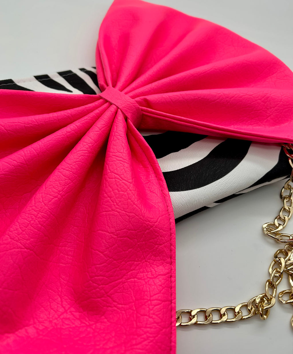 Zebra print bag with large neon pink bow