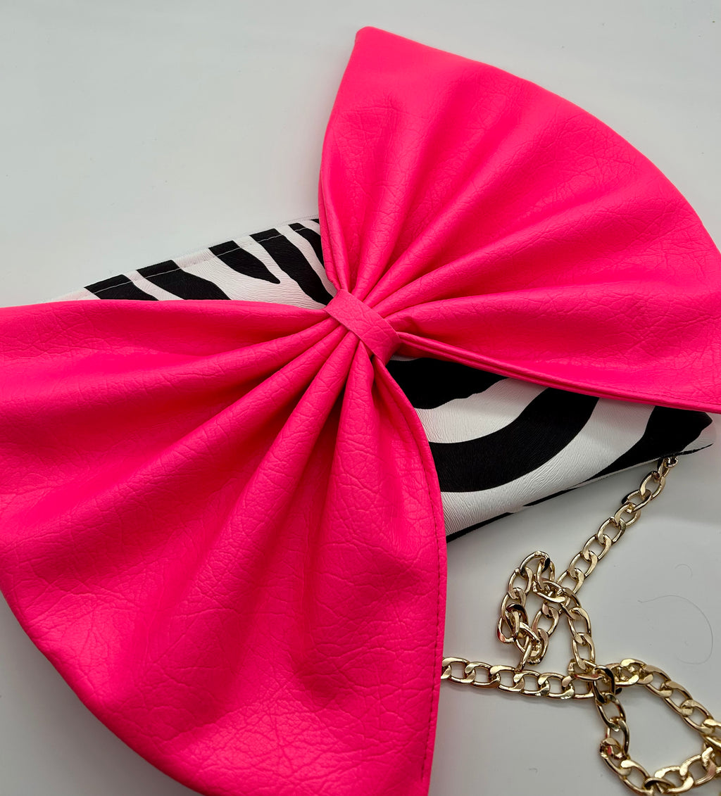 Zebra print bag with large neon pink bow