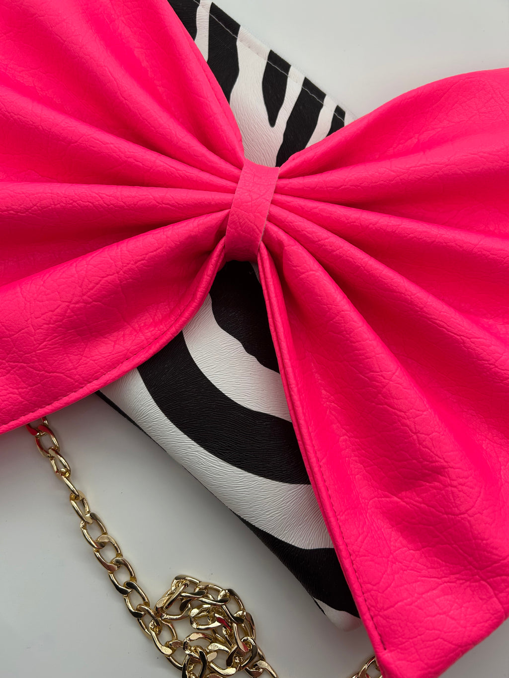 Zebra print bag with large neon pink bow