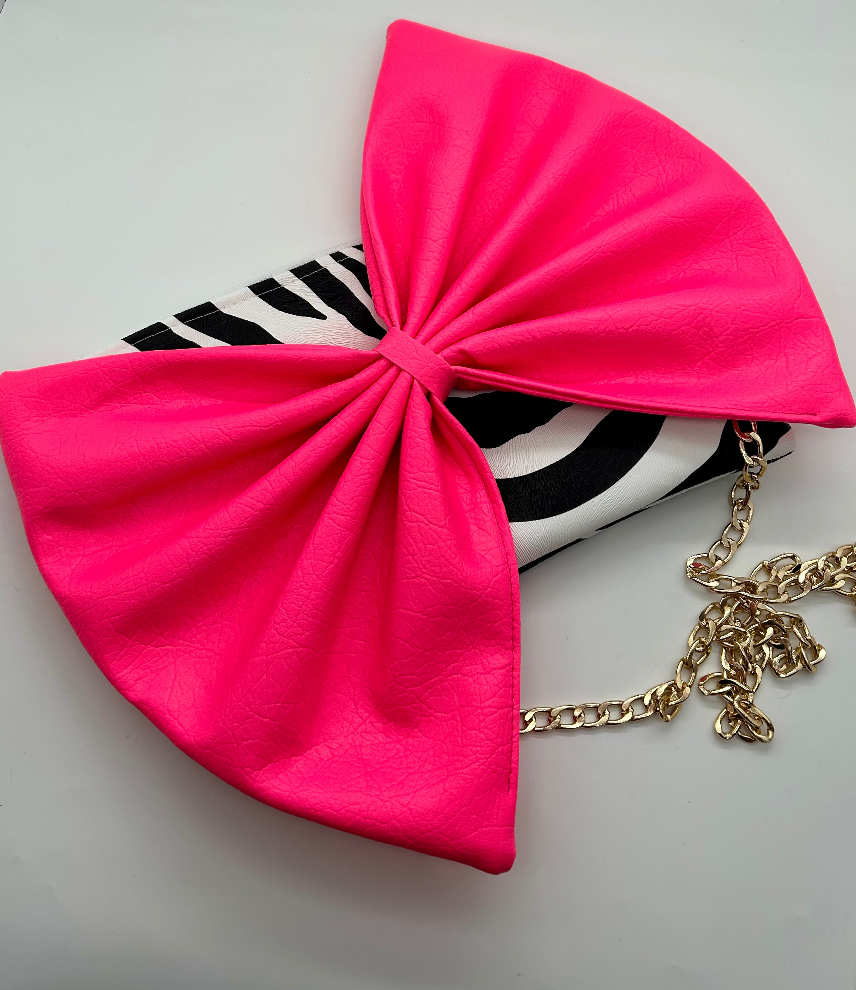 Zebra print bag with large neon pink bow