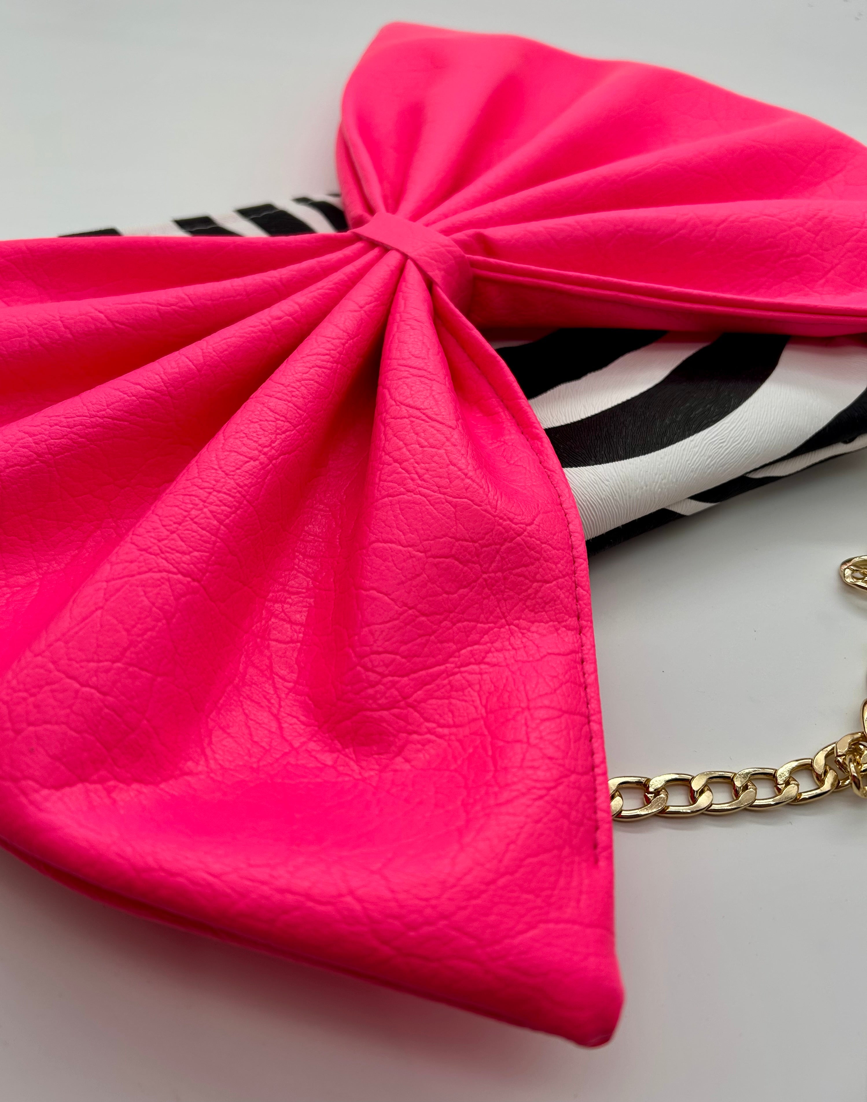 Zebra print bag with large neon pink bow